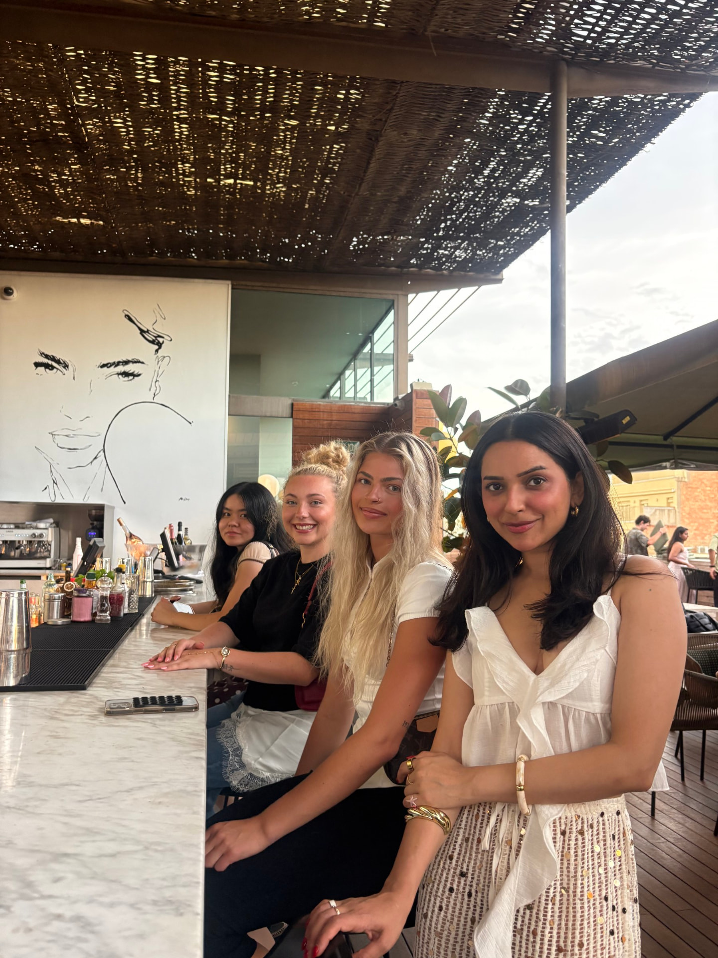 Friends sharing drinks together at a bar on a trip