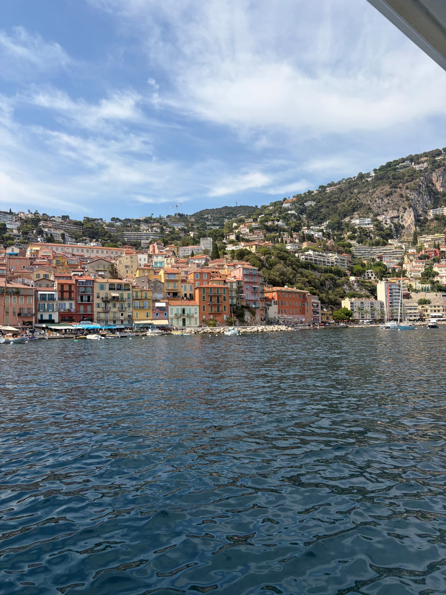 A colourful French Riviera village seen from the water on a clear summer day